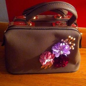 Selling a gray handbag with flowers on it